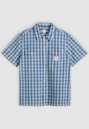 Blue and white short-sleeve button-up shirt with plaid pattern, two chest pockets, and a small red and white brand label on the left pocket.