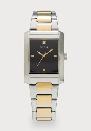 Rectangular Guess watch with a black face and gold accents. Stainless steel bracelet interspersed with gold links. Square markers and crown.