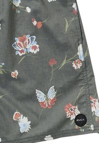 Floral-patterned fabric featuring butterflies and flowers in red, blue, and white on a dark green background. Includes RVCA logo patch.