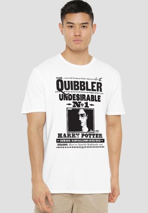 Man wearing white t-shirt with black "The Quibbler Undesirable No. 1 Harry Potter" front print resembling a wanted poster.