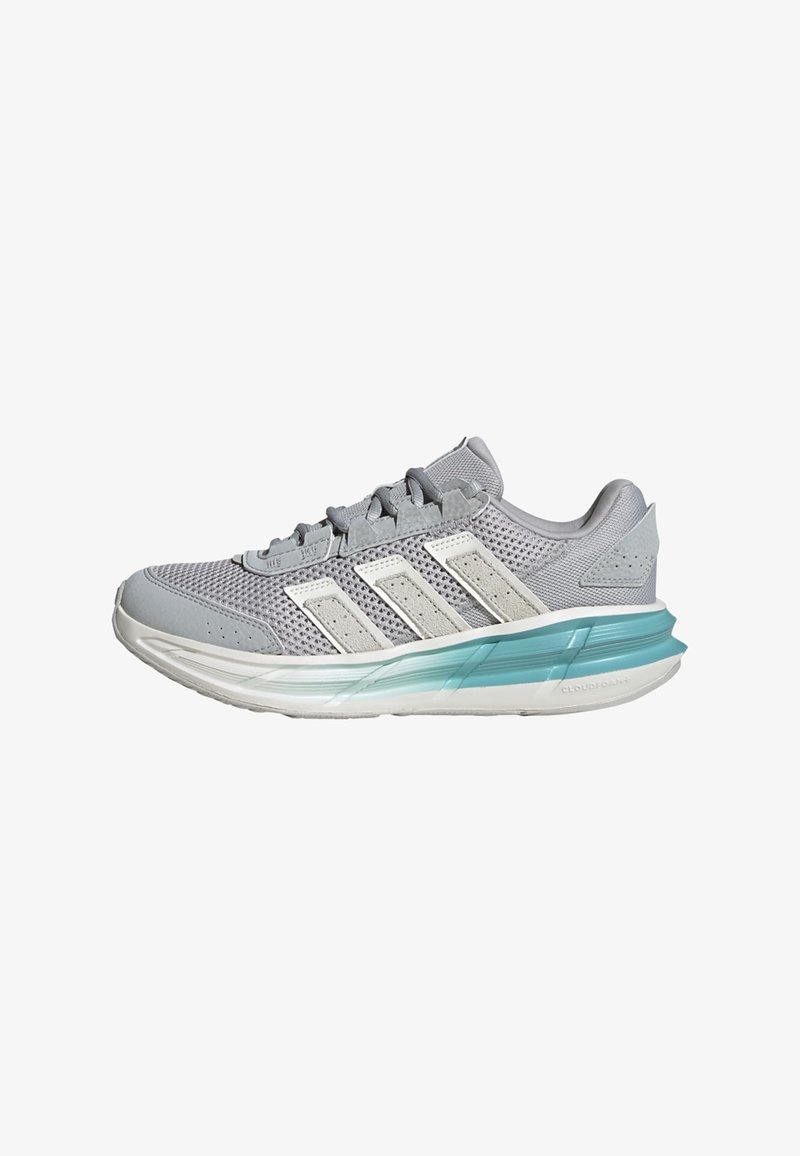 Light gray athletic shoe with mesh upper, white accents, and a teal-tinted sole. Features textured surface and a lace-up design.