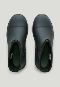 Black waterproof ankle boots with elastic side panels and a textured finish; features green insoles and a smooth rubber sole.