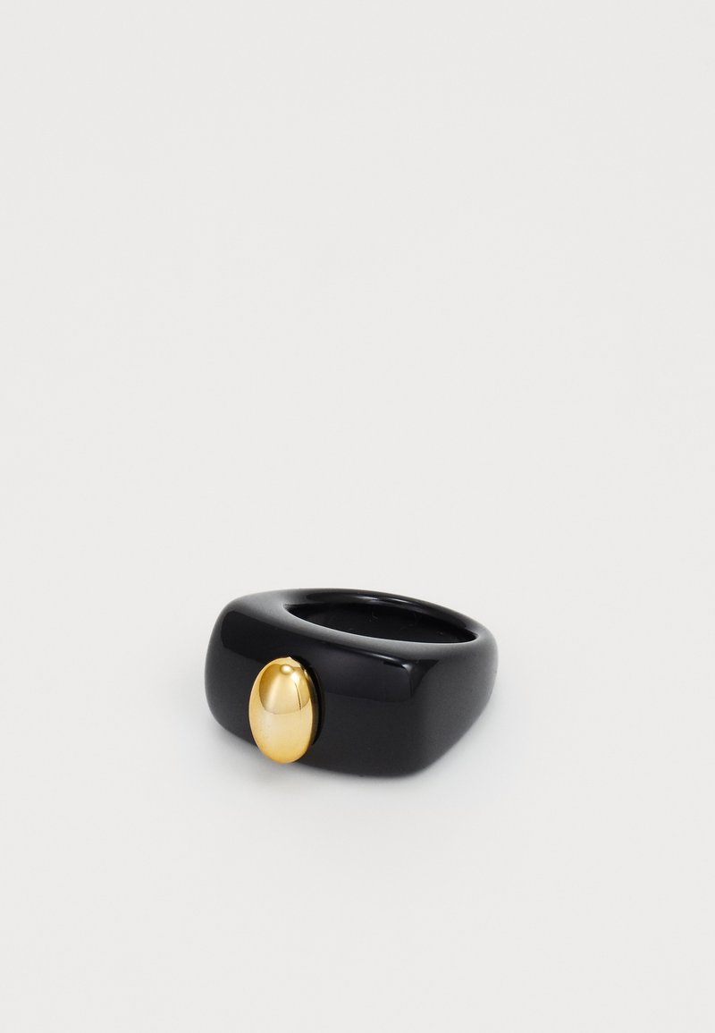 Black resin ring with a smooth, rounded design featuring a polished gold oval accent on the front.