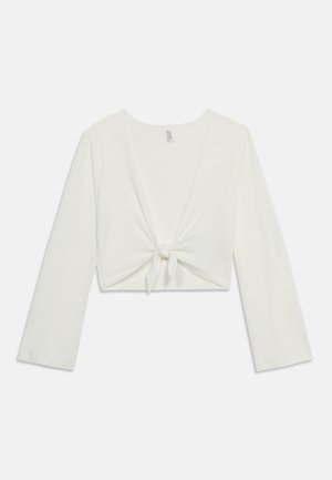 Valge pikkade varrukatega lühike särk sügava V-kaelusega ja eesäärega, esitatud lameda pinnaga ühtlase heleda taustal.