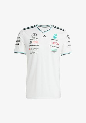 Weißes kurzärmliges Trikot mit V-Ausschnitt, mit schwarzen und türkisfarbenen Akzenten. Zeigt verschiedene Sponsor-Logos auf der Vorderseite und den Ärmeln. Hergestellt aus strukturiertem Stoff.