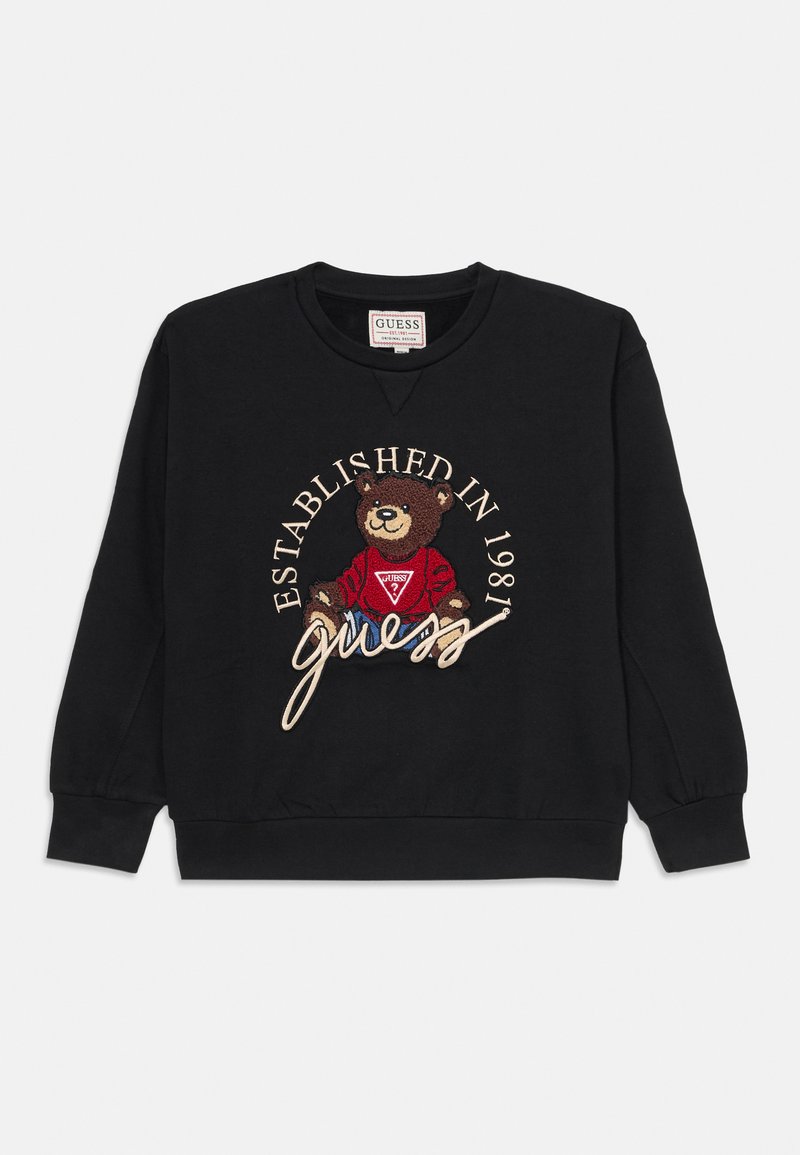 Sweatshirt noir avec un graphique de ours brodé, le texte "Établi en 1981" et une signature en beige clair. Col rond et manches longues.
