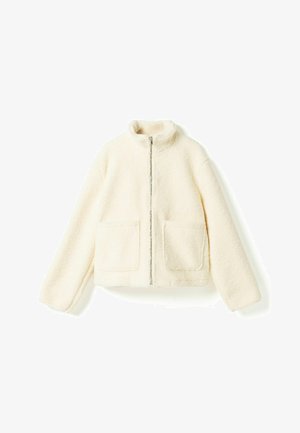Kremfarget fleecejakke med hel glidelås foran, to frontlommer og høy krage, vist på hvit bakgrunn.