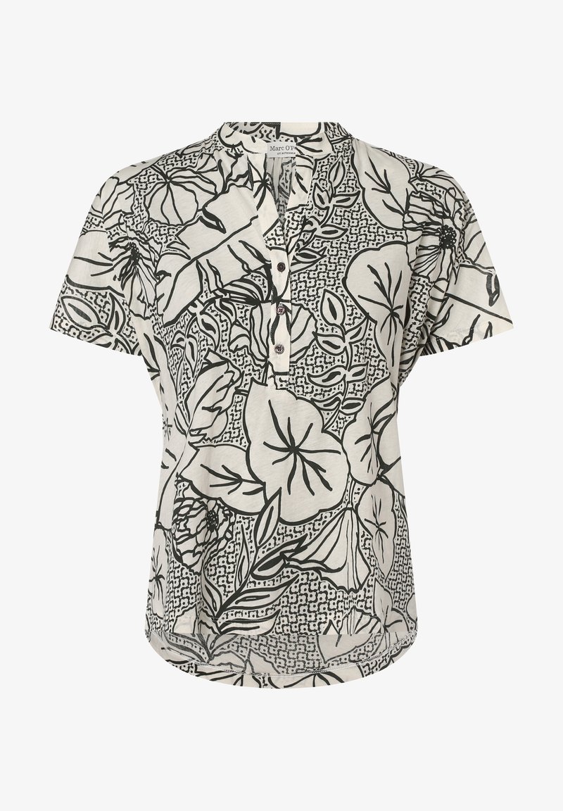 Blouse blanche à manches courtes avec des motifs floraux et feuillages abstraits noirs, boutonnée sur le devant et col rond.
