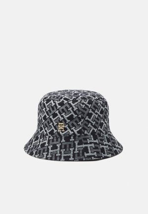 Zwart- en grijsgepatroeerde bucket hat met herhalend geometrisch ontwerp en klein logo-embleem in goudkleur aan de voorkant.