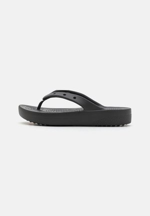 Black rubber flip-flop sandal with textured footbed, perforated upper strap, and thick supportive sole, shown from side view on white background.