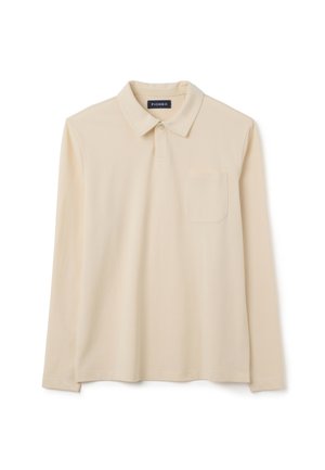 Polo a maniche lunghe di colore beige realizzato in tessuto morbido, con colletto, apertura con bottoni e una tasca sul petto. Design semplice.