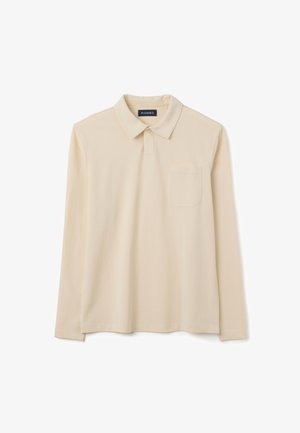 Polo a maniche lunghe di colore beige realizzato in tessuto morbido, con colletto, apertura con bottoni e una tasca sul petto. Design semplice.