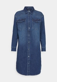 Jeansskjol i mörkblått, med krage, två bröstfickor, knappstängning framtill och långa ärmar med knappmanchetter.