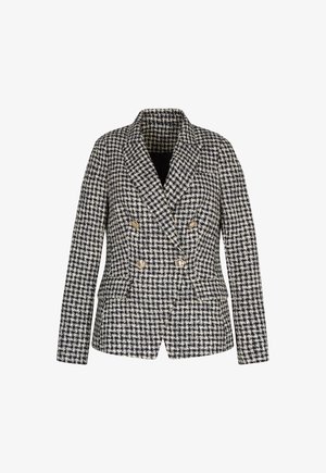 Double-breasted black and white houndstooth patterned blazer with gold buttons and long sleeves on a plain background.