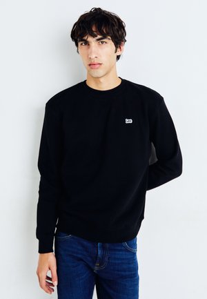Schwarzes Sweatshirt aus Baumwolle mit Rundhalsausschnitt, gerippten Bündchen und kleinem weißen "Lee"-Logo auf der linken Brust.