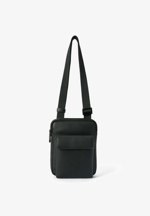 Black leather shoulder bag with adjustable fabric strap, zippered top, and front pocket. Smooth texture, compact rectangular shape.