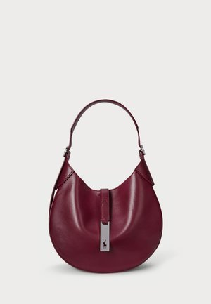 Bolso hobo de cuero burdeos con forma curva, mango corto y un detalle de hardware en tono plateado que incluye un logotipo en el cierre.