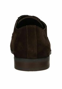 Brown suede shoe featuring a smooth texture, rounded shape, and a low heel, with stitching details along the sides and rear.