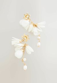 Gold-tone earrings feature white petal shapes and floral accents, adorned with dangling pearls. Delicate and intricate design details present.