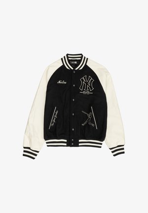 Melna un krēmkrāsas varsity stila jaka ar vilnas ķermeni, ādas piedurknēm, ribotas aprocēm, izšūtām emblēmām un grafiskajiem attēliem ar beisbola spēlētāju un tekstu.