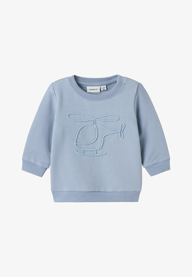 Felpa azzurro chiaro con un design di elicottero ricamato e testurizzato in una tonalità a contrasto. Collo e polsini a coste. Tessuto morbido.