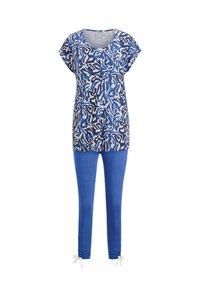 Blauw patroon kortom shirt gecombineerd met effen blauwe aansluitende leggings met kleine gestrikte strikjes bij de enkels.