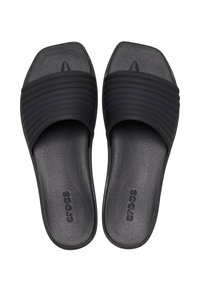 Black Crocs slide sandals with textured footbeds and wide ribbed straps, featuring a toe separator and slip-on design.