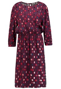 Bordové šaty s kulatým výstřihem a dlouhými rukávy. Mají nařasený pas a vzor barevných, nepravidelných teček. Lehká tkanina.