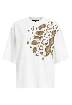 T-shirt bianca in cotone con vestibilità over, caratterizzata da una stampa leopardata dorata sul davanti. Collo tondo e maniche corte.