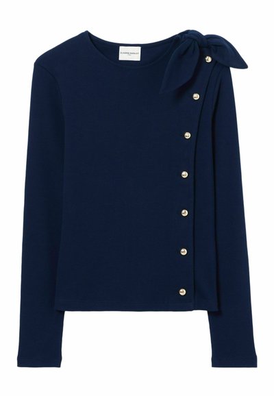 Top lungo navy con dettaglio a fiocco sulla spalla sinistra, bottoni decorativi ai lati e una texture di tessuto liscia.