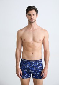 Blue patterned boxers made of lightweight fabric, featuring a navy waistband with "BJÖRN BORG" logo. Short, form-fitting cut.
