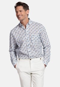 Lange mouwen overhemd met een lichtblauwe kleur en een klein, veelkleurig bloemenpatroon. Bevat een enkele borstzak en knoopmanchet.