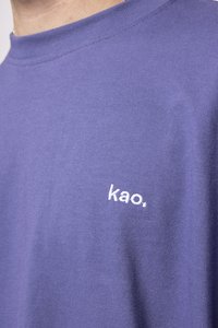 Purple cotton t-shirt featuring a crew neckline and short sleeves. Notable detail: white embroidered logo "kao." on the chest.