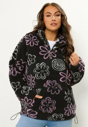 Zwarte fleece pullover met een kwartrits, voorzien van bloemenpatronen in roze en wit. Inclusief een voorkant zak en verstelbare zoom.