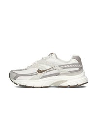 White and gray running shoe with mesh and synthetic materials, rounded toe, layered design, textured accents, and rubber sole.