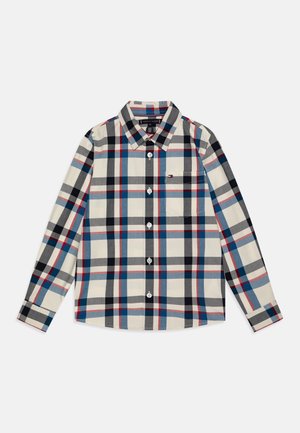 Chemise boutonnée en mélange de coton, présentant un motif à carreaux crème, noir, bleu et rouge. Manches longues, col et poche poitrine présents.