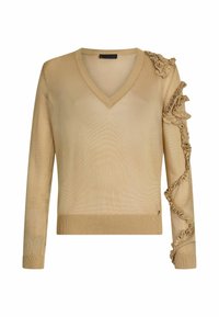 Pull beige à col en V avec manches longues, présentant des détails en tricot volanté le long de l'épaule droite et du bras.