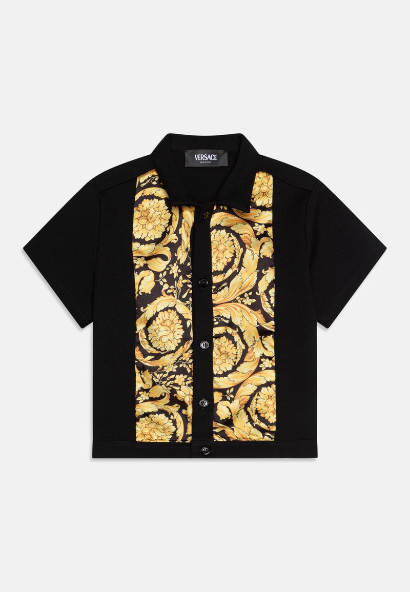 Short-sleeve black shirt featuring a gold floral patterned panel. Button-up front with a collar. Soft, smooth texture. Versace branding visible.