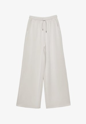 Pantalons larges gris clair en tissu doux avec une taille élastique, un cordon de serrage ajustable et des poches latérales. Texture lisse sur l'ensemble.