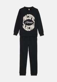 Black cotton sweatshirt and pants set featuring a circular "PACIFIC Athletic" graphic in cream. Ribbed cuffs and waistband for comfort.