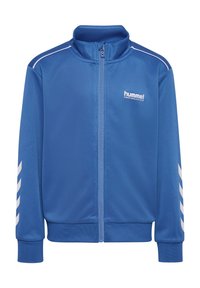 Veste de sport bleue à fermeture éclair complète avec logo hummel blanc sur la poitrine et bandes chevrons blanches sur les manches, avec poignets et col côtelés.