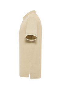 Polo beige à manches courtes avec col et bordure blanche aux manches, présenté de profil sur un fond blanc.