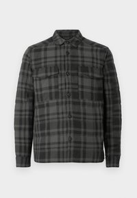 Black and dark gray plaid button-up shirt jacket with collar, long sleeves, and two flap chest pockets.