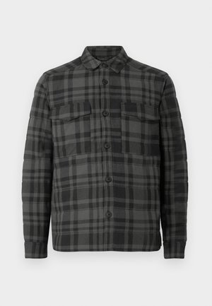 Chemise-veston à carreaux noirs et gris foncé avec col, manches longues et deux poches poitrine à rabat.
