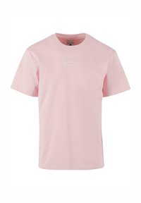 Light pink cotton t-shirt with a crew neck, short sleeves, and white embroidered text at the chest. Smooth texture, casual fit.