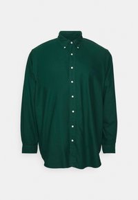 Mörkgrön skjorta med knappar i bomull, med långa ärmar, klassisk krage och en liten logotyp på bröstet.