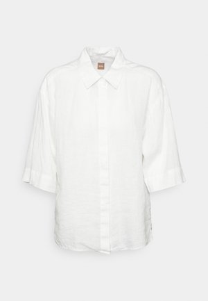 White short-sleeve shirt made of linen, featuring a button-down front, classic collar, and a relaxed fit. No visible patterns or hardware.