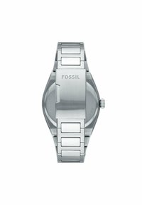 Ur i rustfrit stål med poleret finish, linked armbåndsdesign og minimalistisk urkasse. Inkluderer logoet "FOSSIL" på spænde.