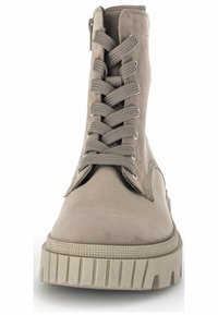 Beige ankle boot with a smooth suede finish, rubber sole, and rounded toe. Features laces and a side zipper for easy wear.