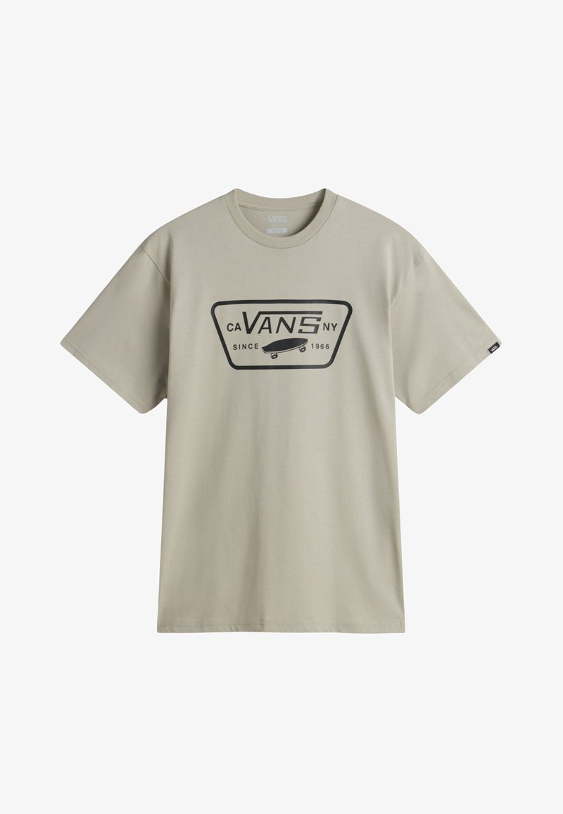 Camiseta de algodón beige de manga corta, con un logo gráfico negro en el frente que incluye una patineta y el texto: "CA VANS NY DESDE 1966."